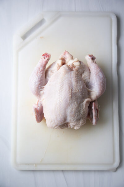 whole chicken on a cutting board