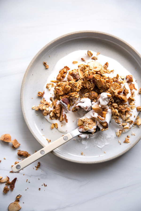 gluten-free granola with no added sugar over dairy-free yogurt on a plate