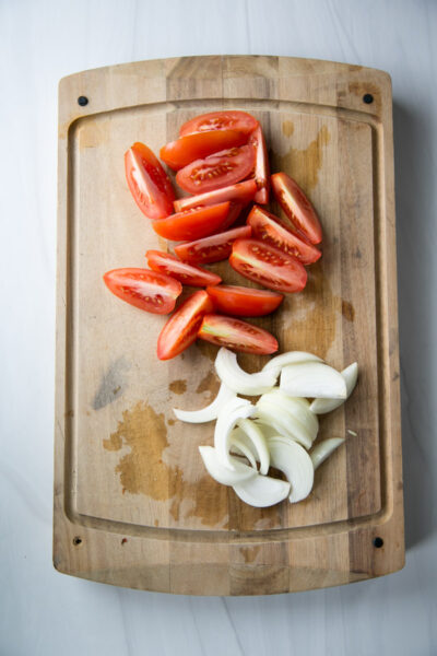 tomatoes and onions on cutting board