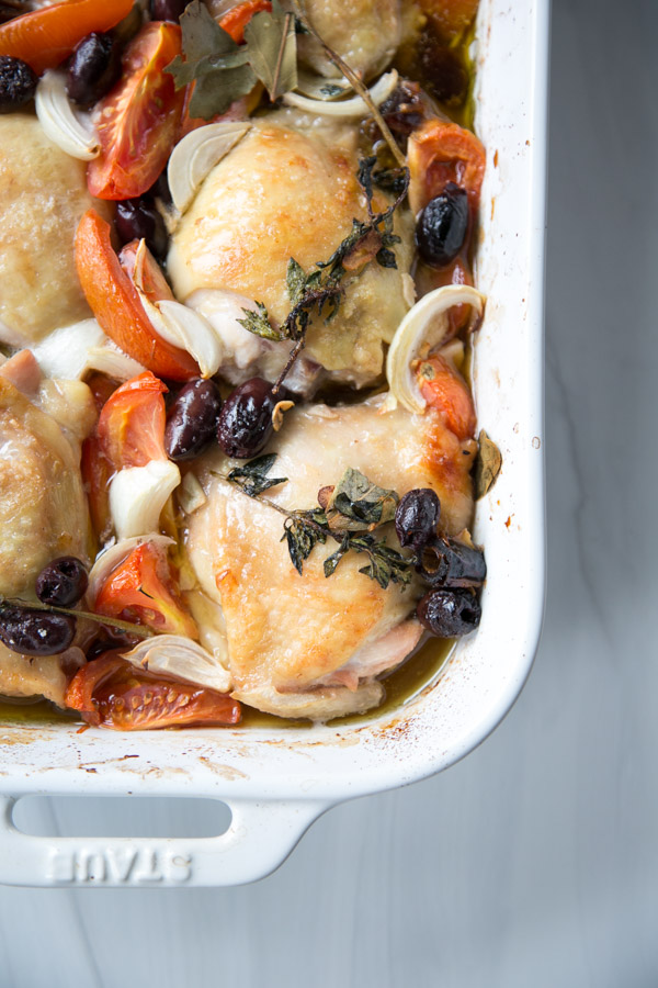 provencal chicken thighs with olives tomatoes and oregano in baking dish