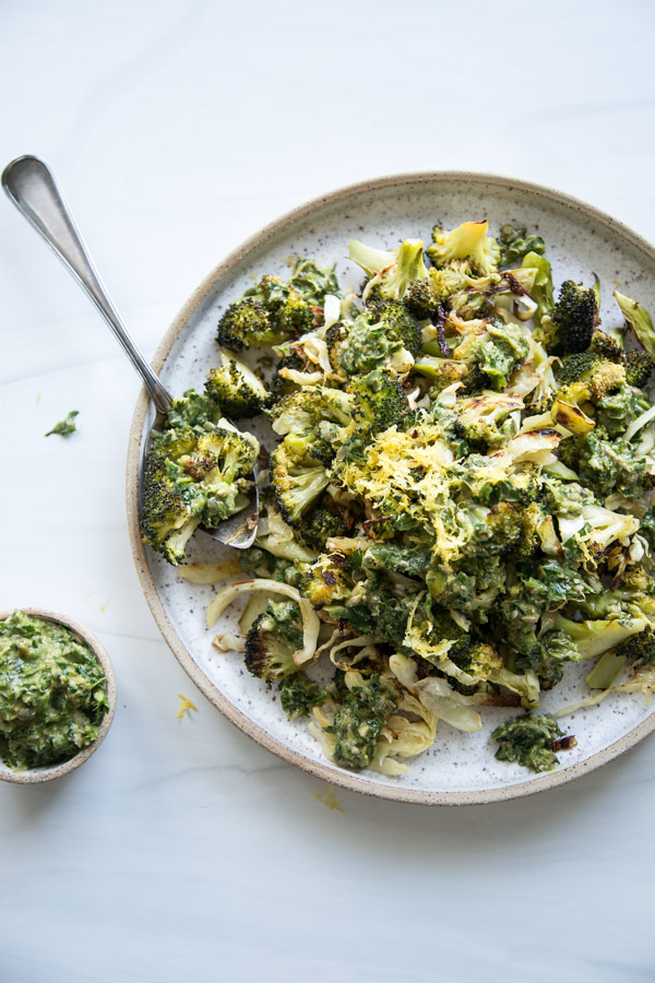 low fodmap roasted broccoli and cabbage on a platter with spoon