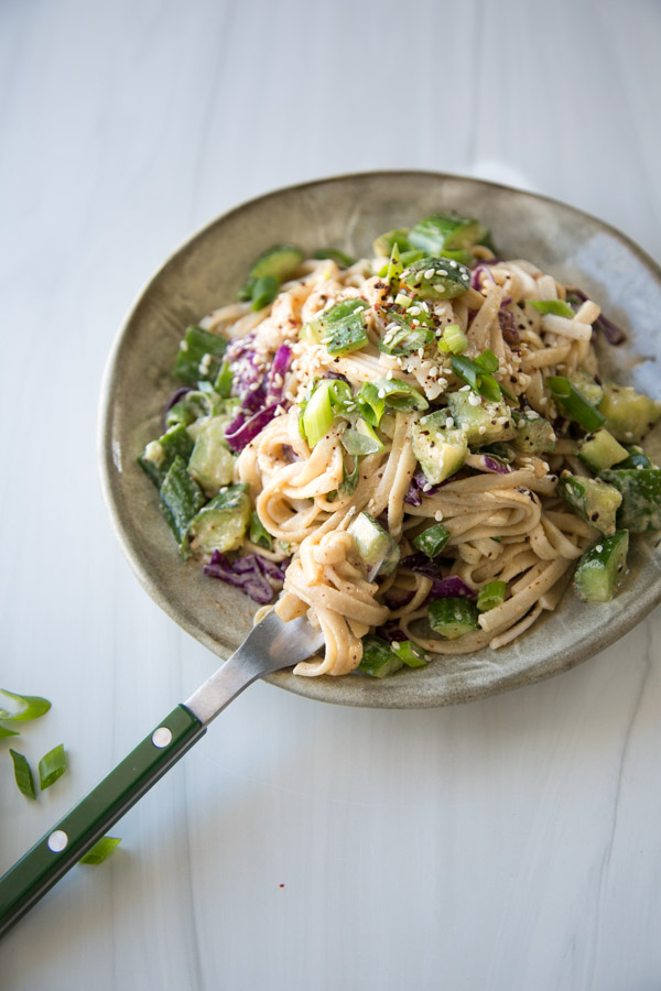 Gluten-free cold Asian sesame noodle salad on plate with fork