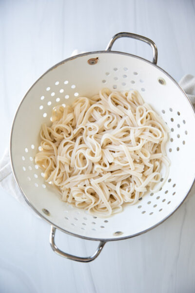 Gluten-free rice noodles in a colander